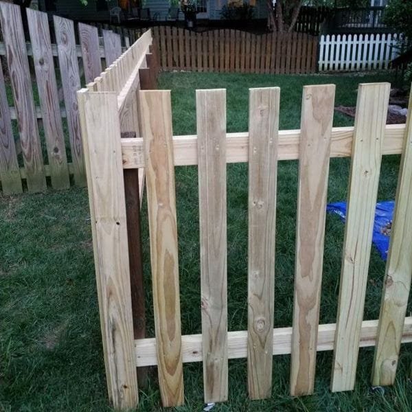 4ft tall spaced picket wood fence with 3-inch gaps between each board installed in a residential yard in Raleigh NC by Innovation’s Fence & Deck