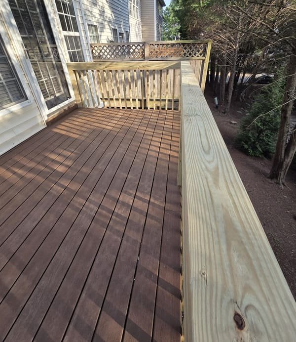 New composite deck boards installation and top handrails by Innovation Fence & Deck in Raleigh, NC